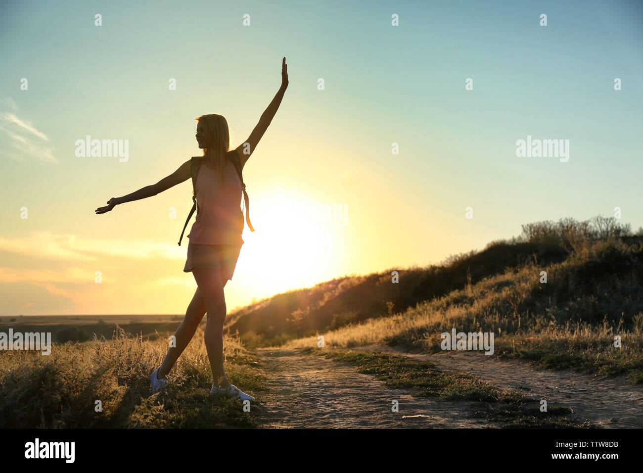 Silhouette of woman on sunset sky background Stock Photo - Alamy