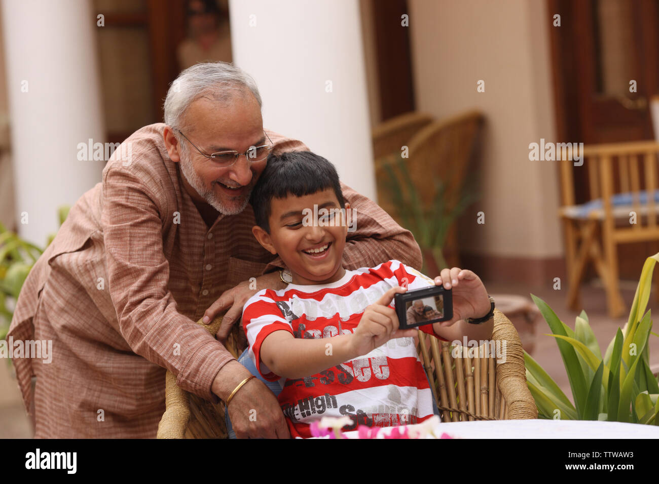 Boy with his father taking picture of themselves Stock Photo - Alamy