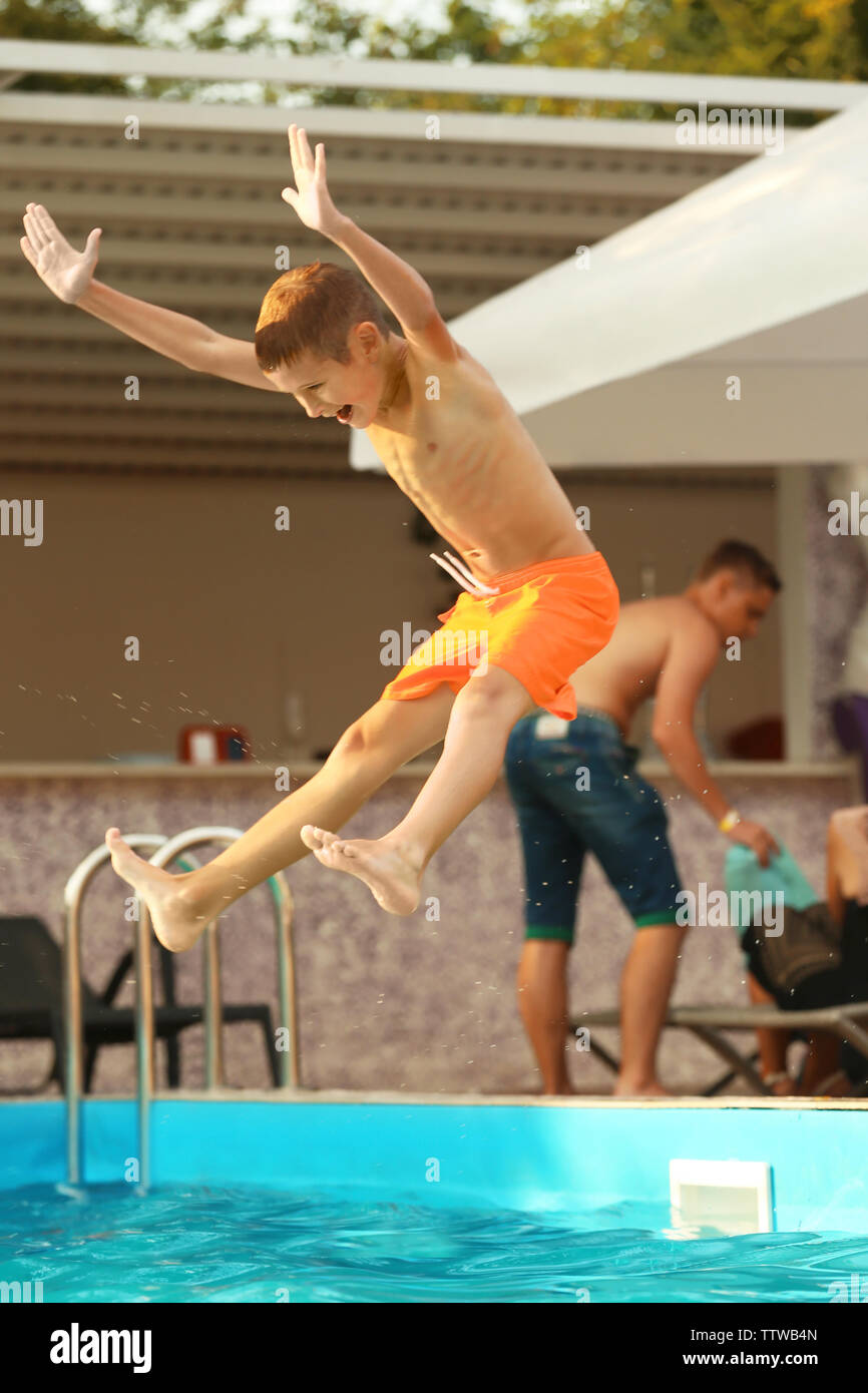 Little boy jumping in swimming pool Stock Photo Alamy