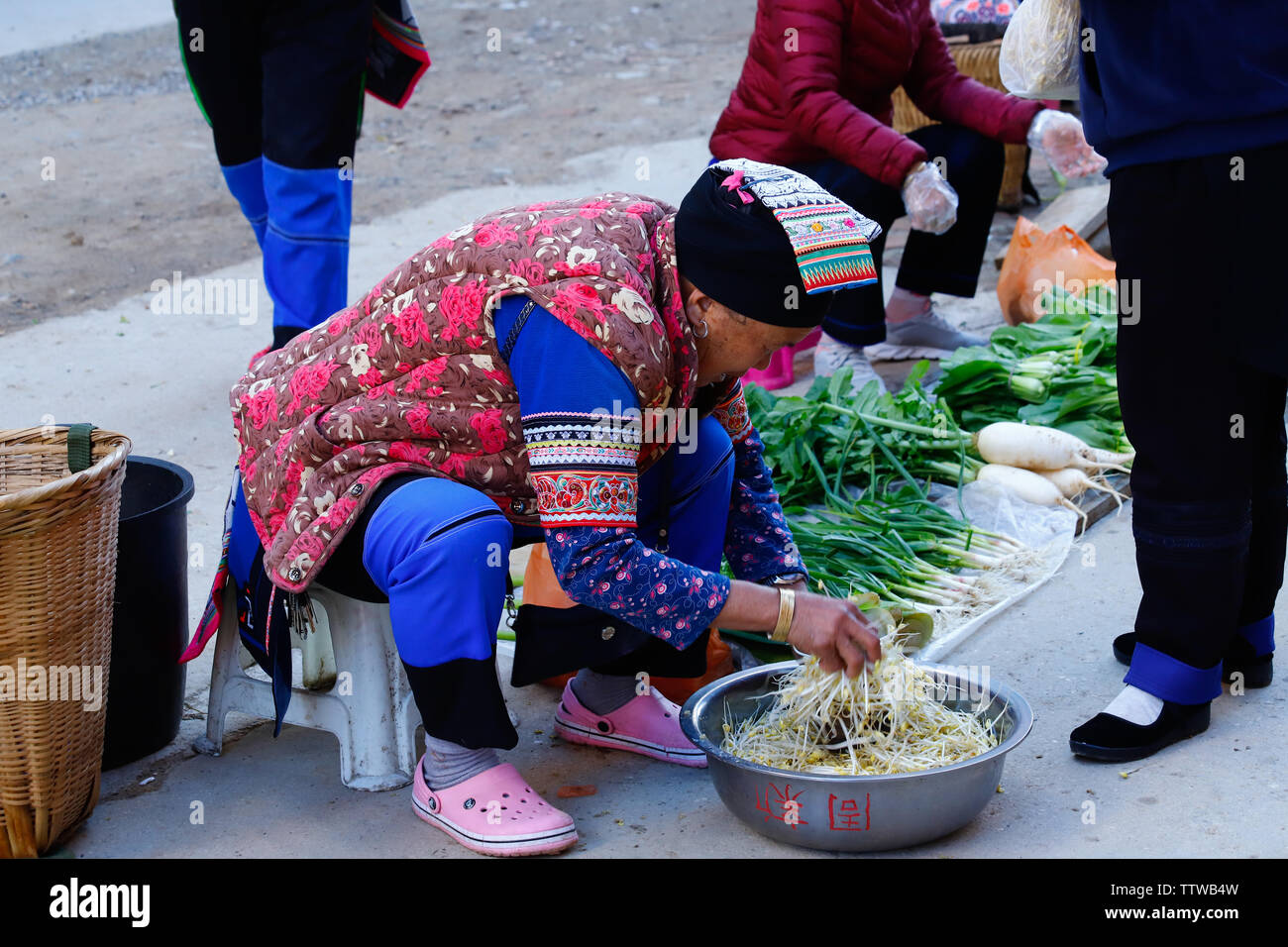 People in typical clothes in a village in southern Yunnan, China. Yunnan, China - November, 2018 Stock Photo