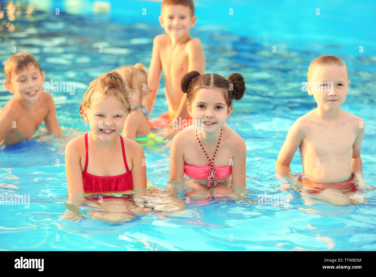 Little kids in swimming pool on sunny day Stock Photo - Alamy