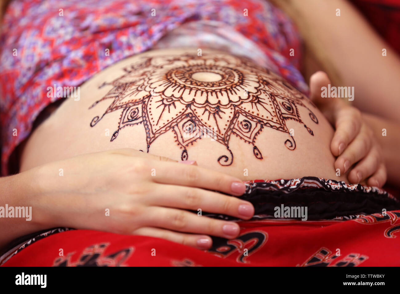 Henna tattoo on pregnant belly Stock Photo by belchonock 126259662