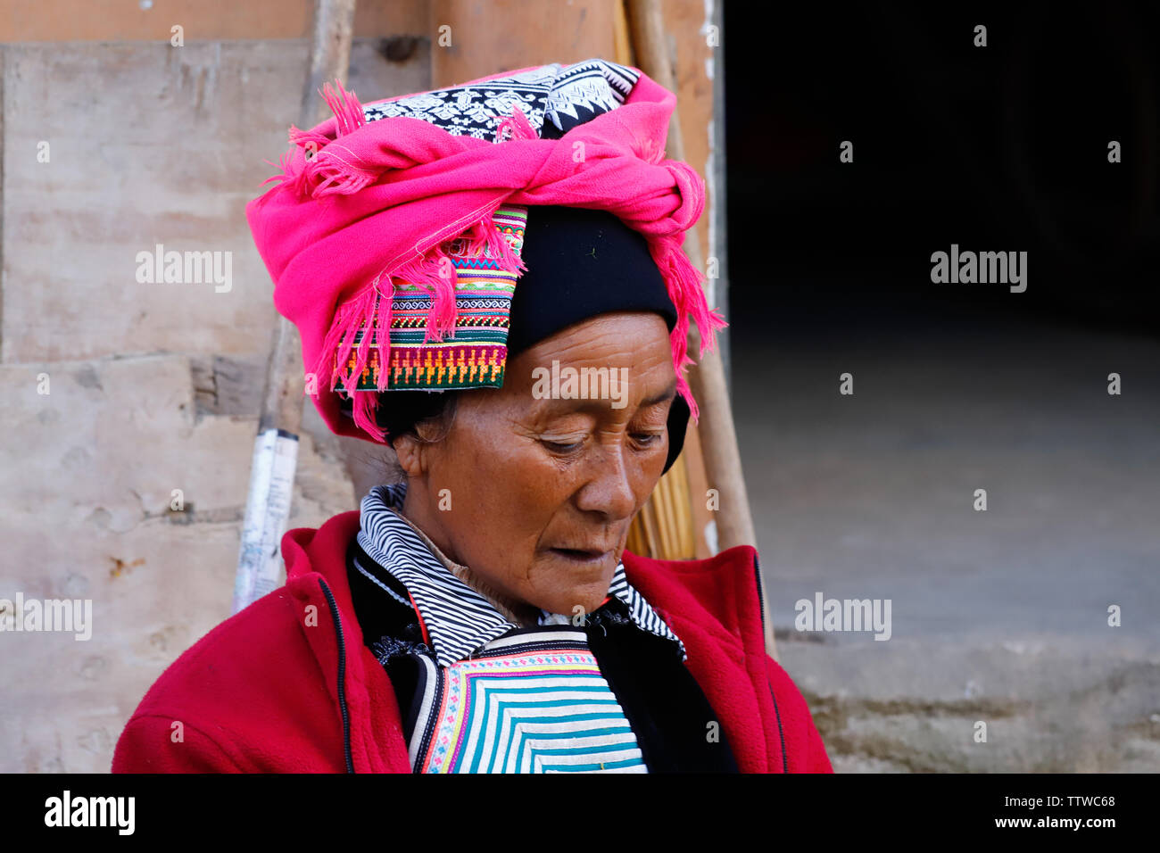 A woman in typical clothes in a village in southern Yunnan, China. Yunnan, China - November, 2018 Stock Photo