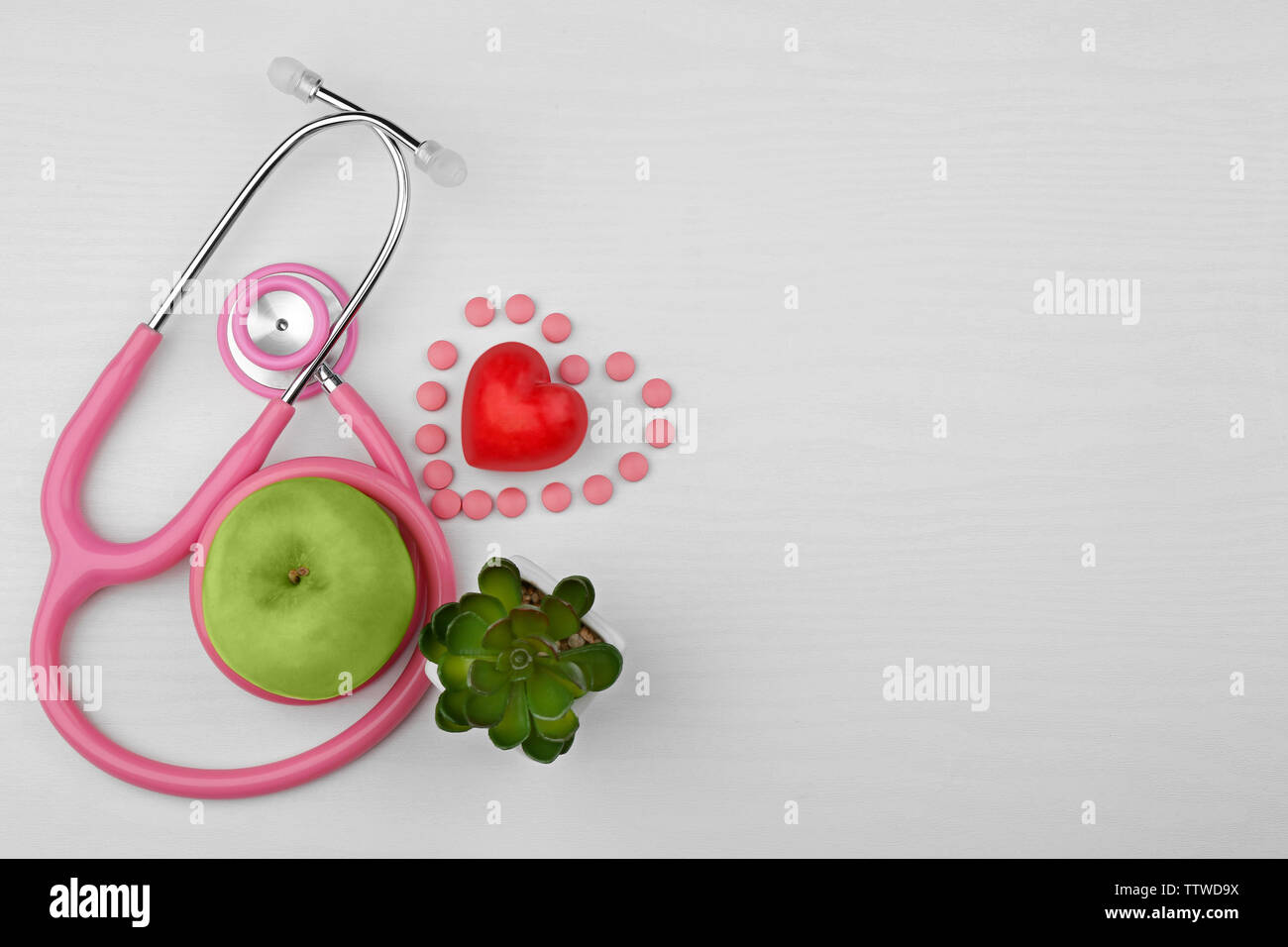 Stethoscope with apple and heart on white background Stock Photo - Alamy