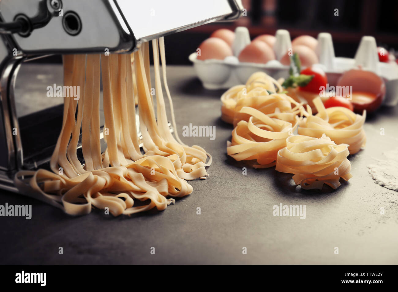 Making tagliatelle by using pasta machine Stock Photo Alamy