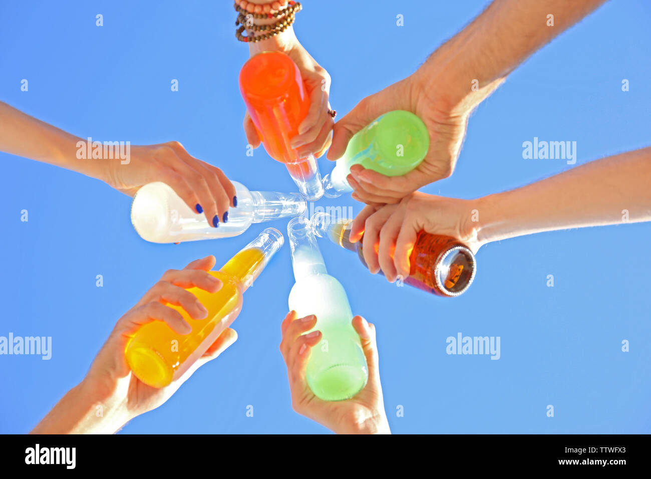 People raising hands to sky with cocktails, bottom view Stock Photo - Alamy