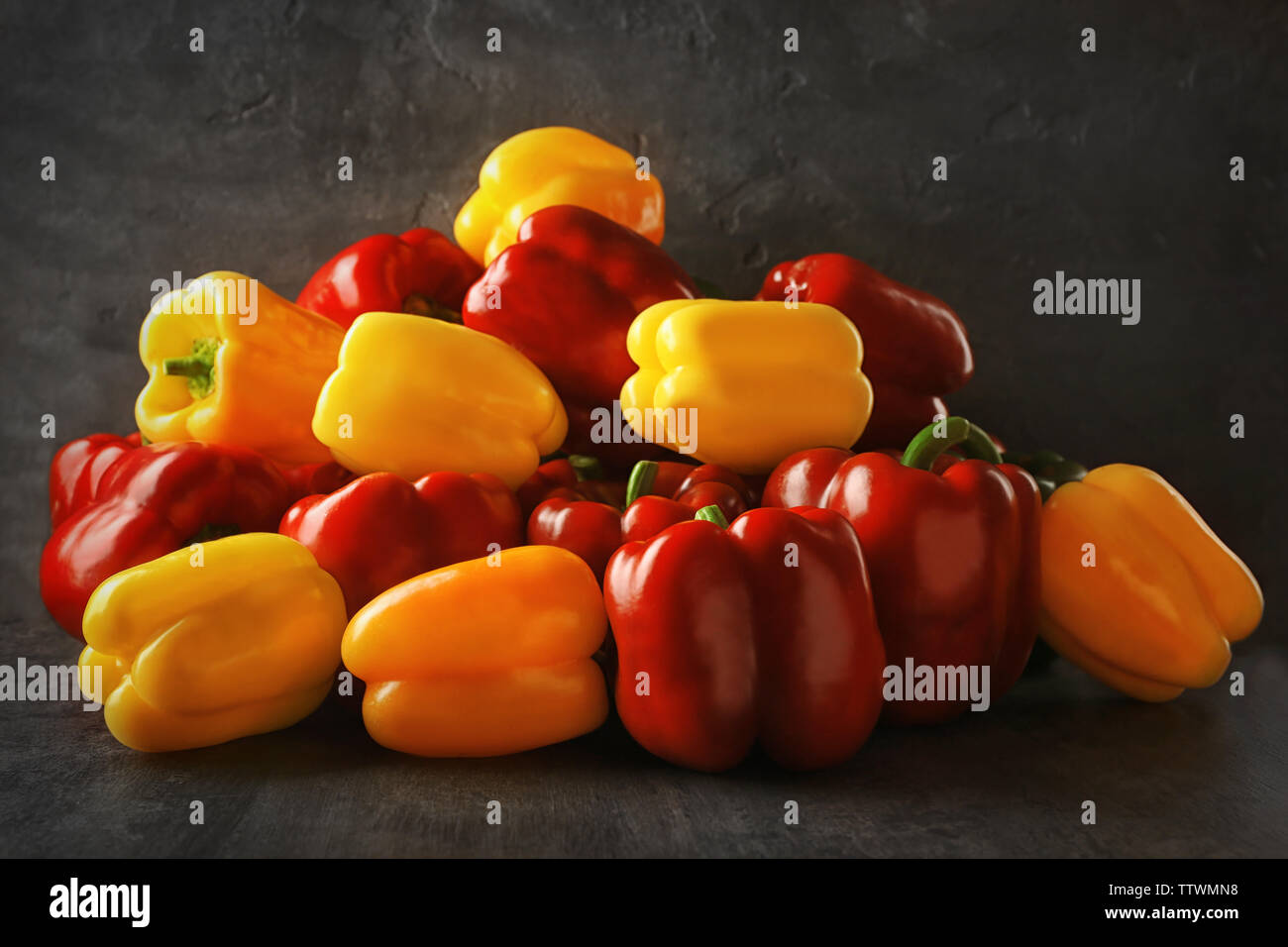 Set of sweet red and yellow peppers on grey background Stock Photo - Alamy