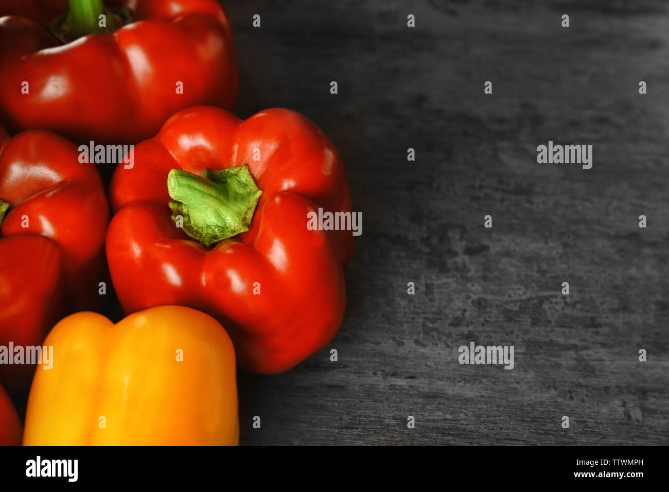Set of sweet red and yellow peppers on grey background Stock Photo - Alamy