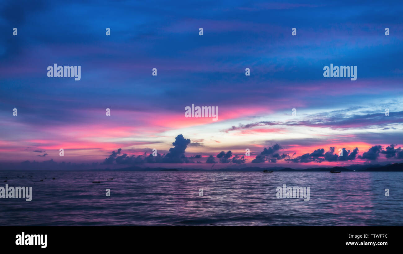 Red sunset fire clouds sky clouds sea view blue sea Stock Photo - Alamy