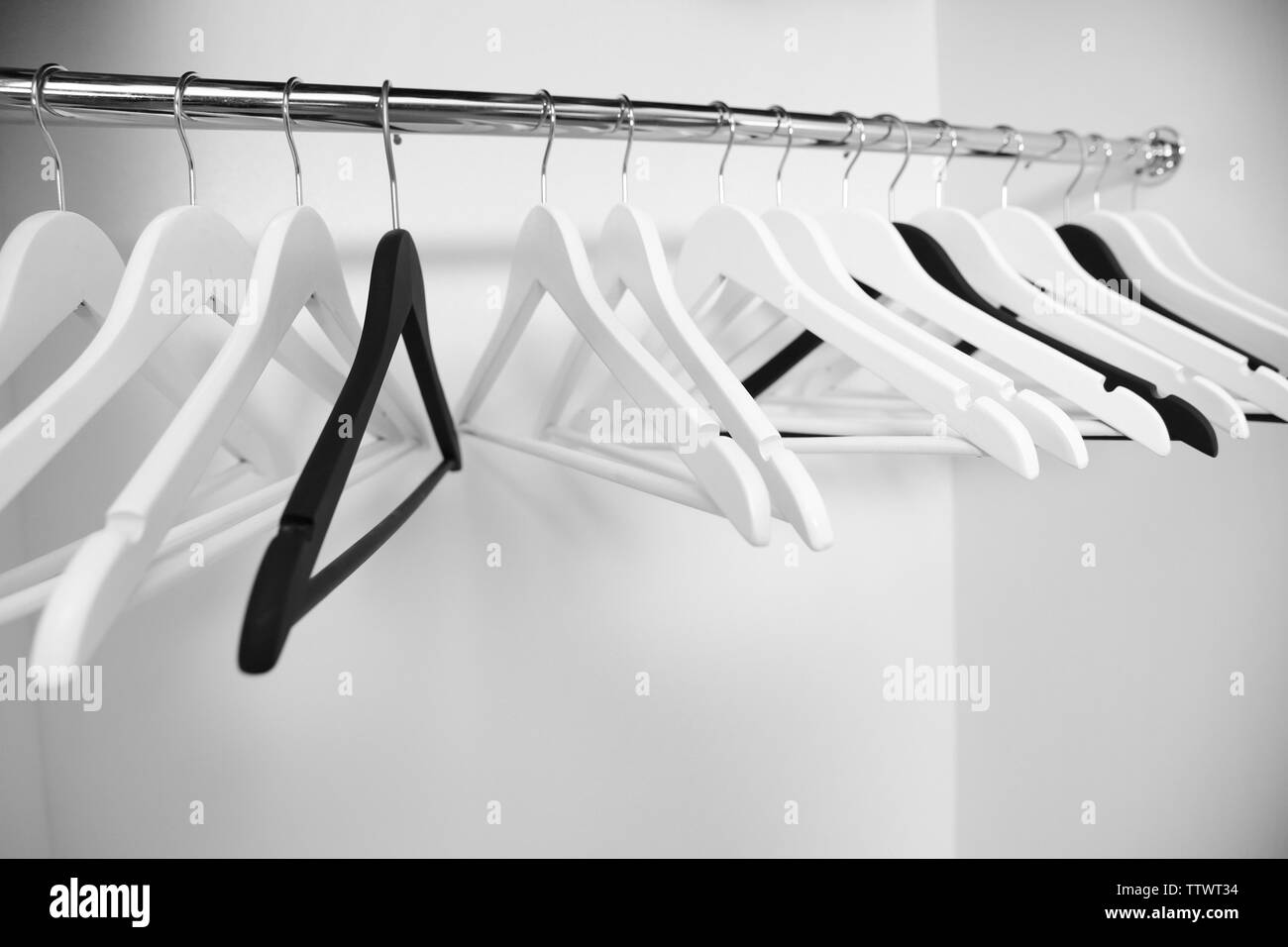 Clothes hangers in empty wardrobe, closeup Stock Photo Alamy