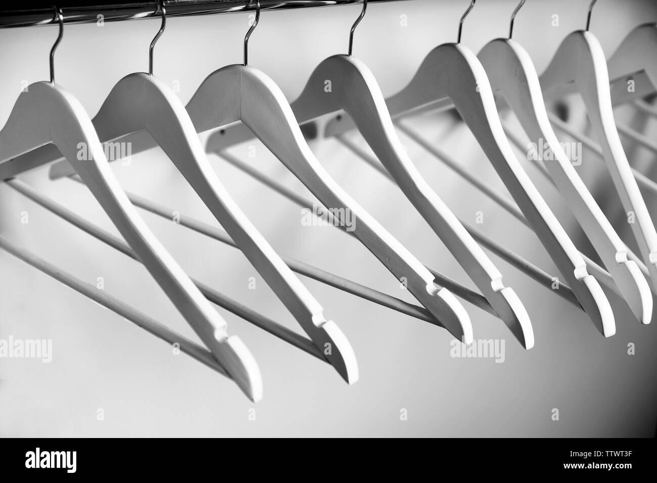 Clothes hangers in empty wardrobe, closeup Stock Photo Alamy
