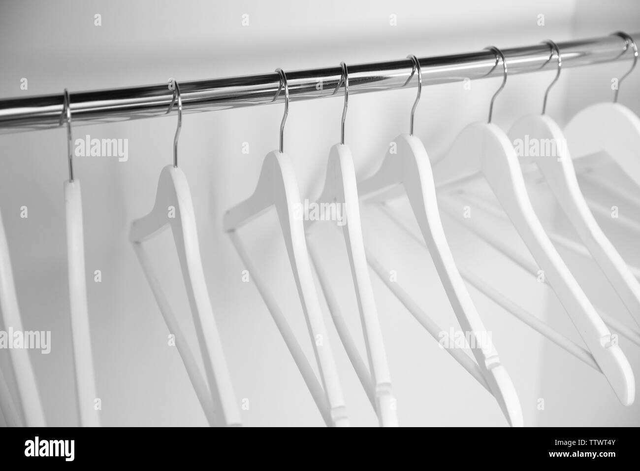 Clothes hangers in empty wardrobe, closeup Stock Photo Alamy