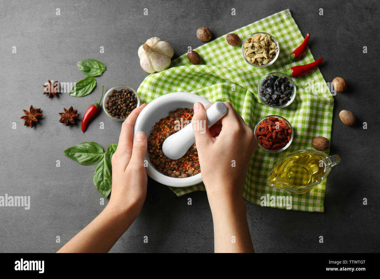 Female hands grinding spices in mortar Stock Photo Alamy