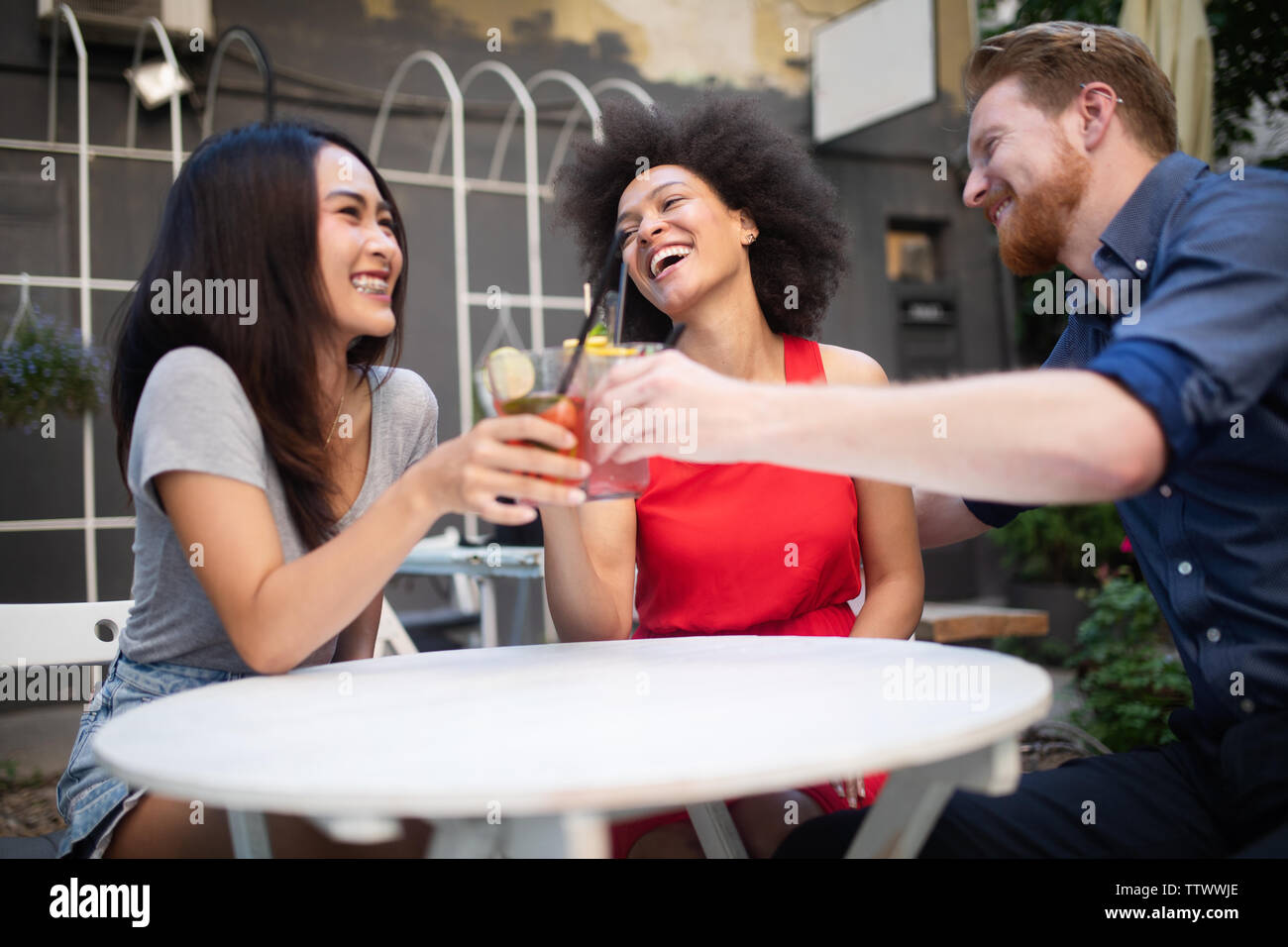 Group of friends having fun together. People talking laughing and enjoying their time Stock Photo