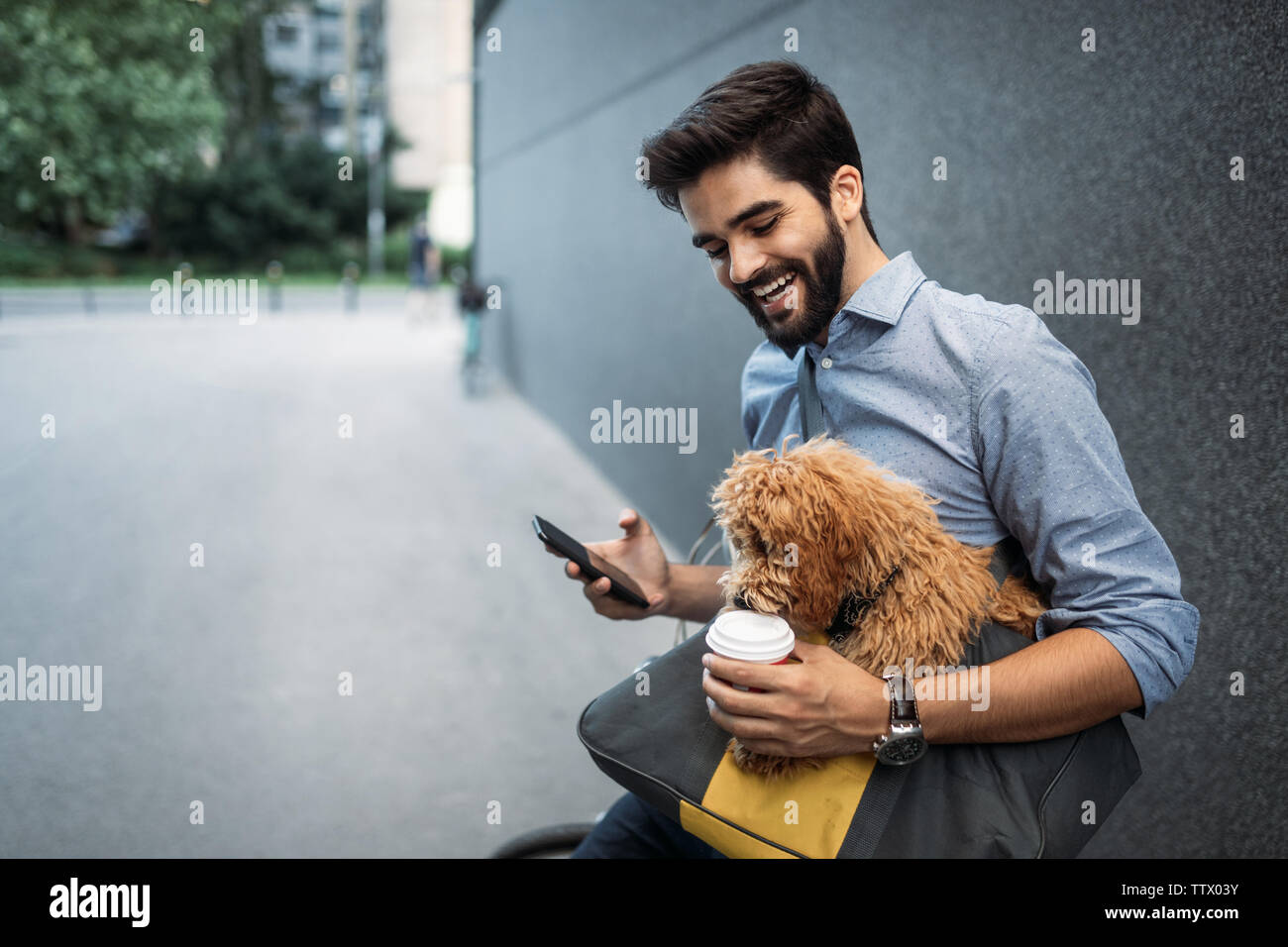 Handsome young man browsing the net during a coffee break. Stock Photo