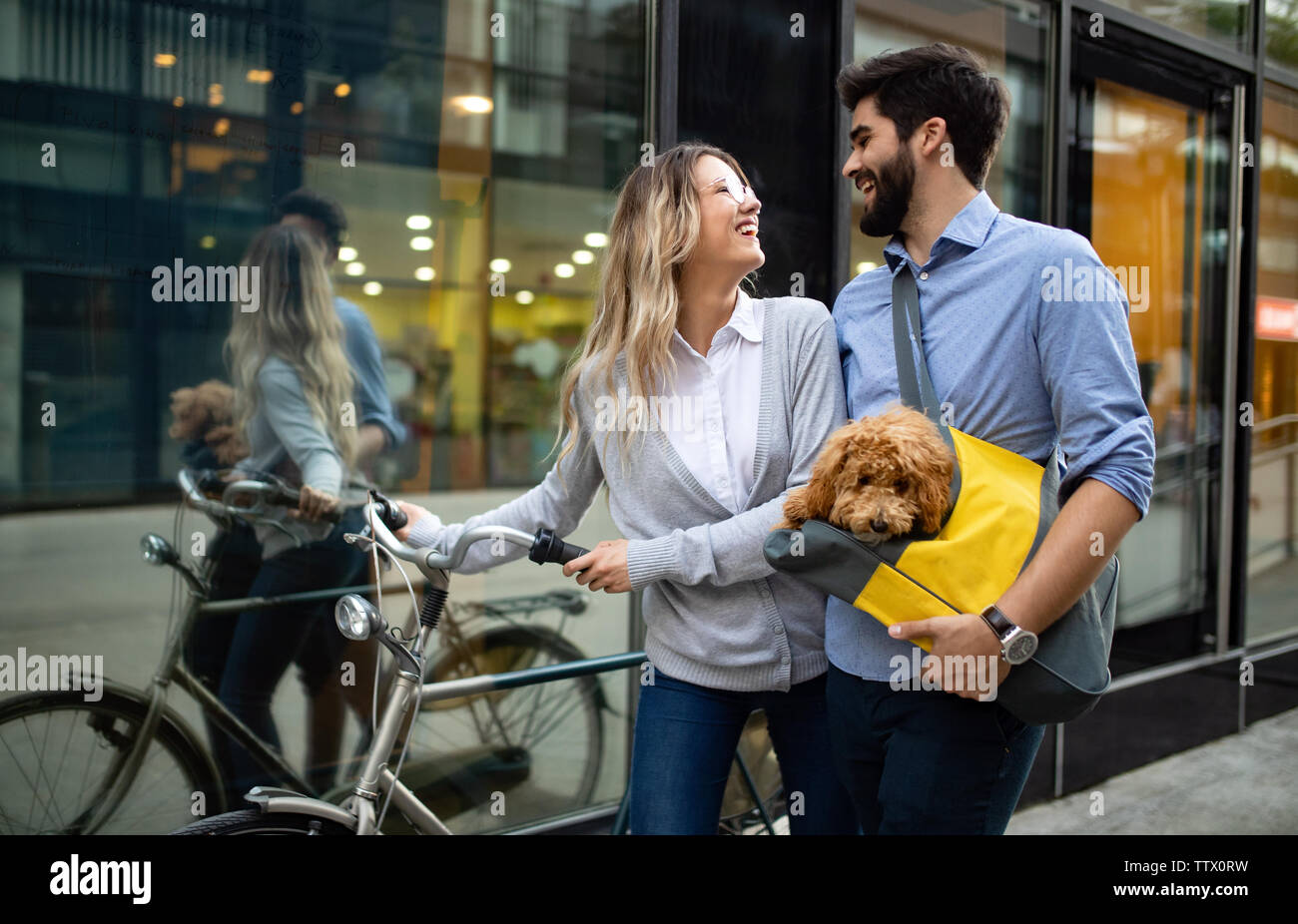 Couple in love with dog walking and smiling outdoor Stock Photo - Alamy