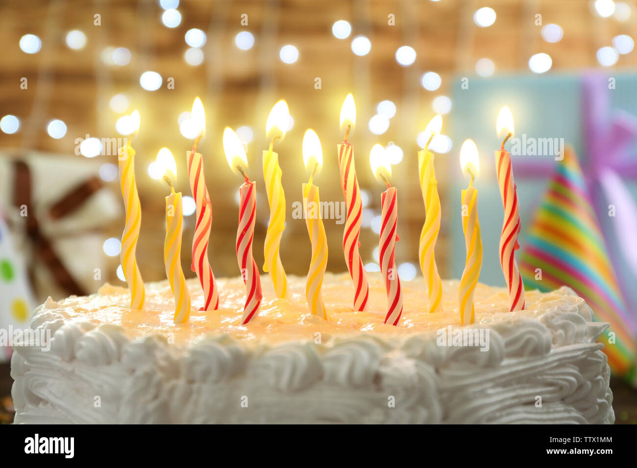 Birthday cake with candles on lights background Stock Photo - Alamy