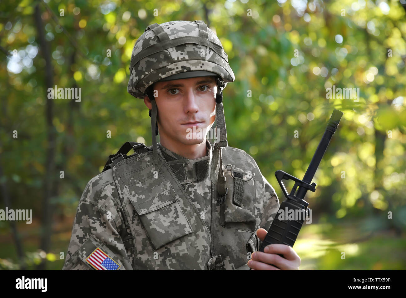 Portrait of soldier with rifle in forest Stock Photo - Alamy