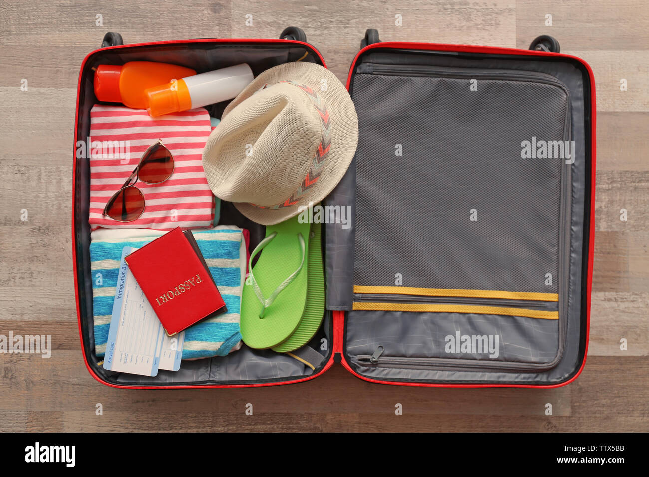 Open suitcase packed for travelling, close up Stock Photo