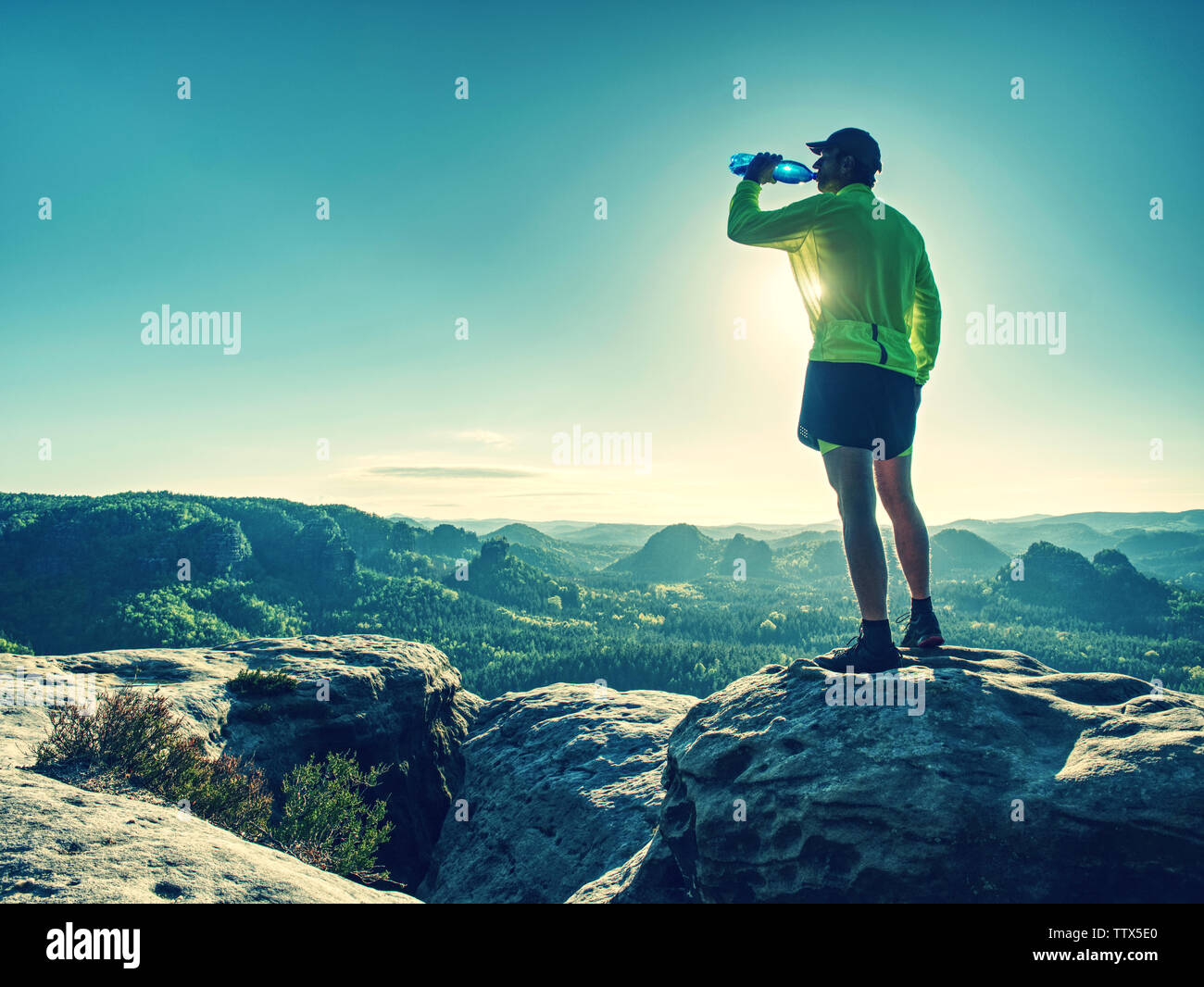 Sports bottle drink sport man drinking water on trail run. Male runner
