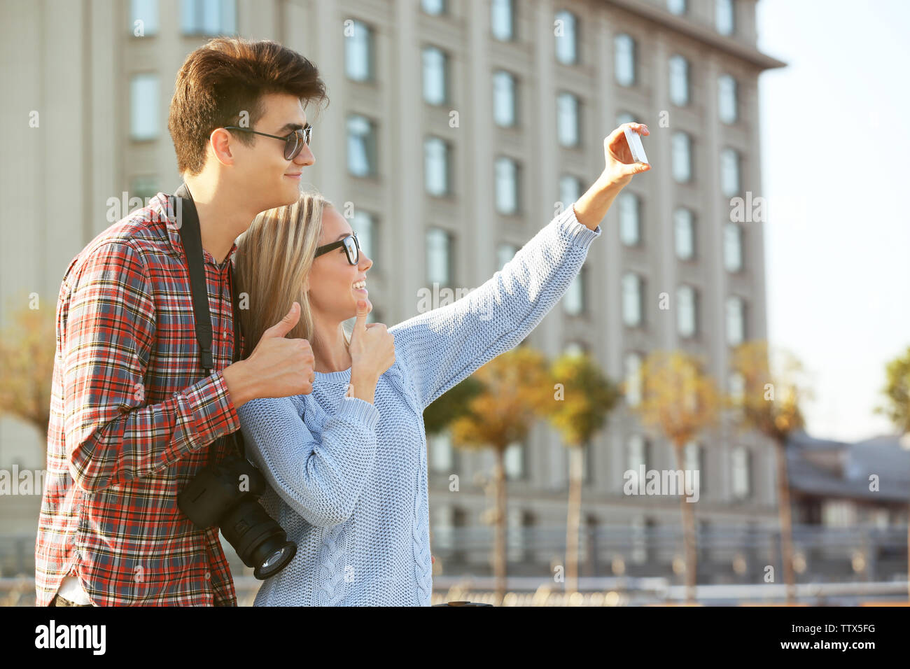 Young couple taking selfie on a street Stock Photo - Alamy