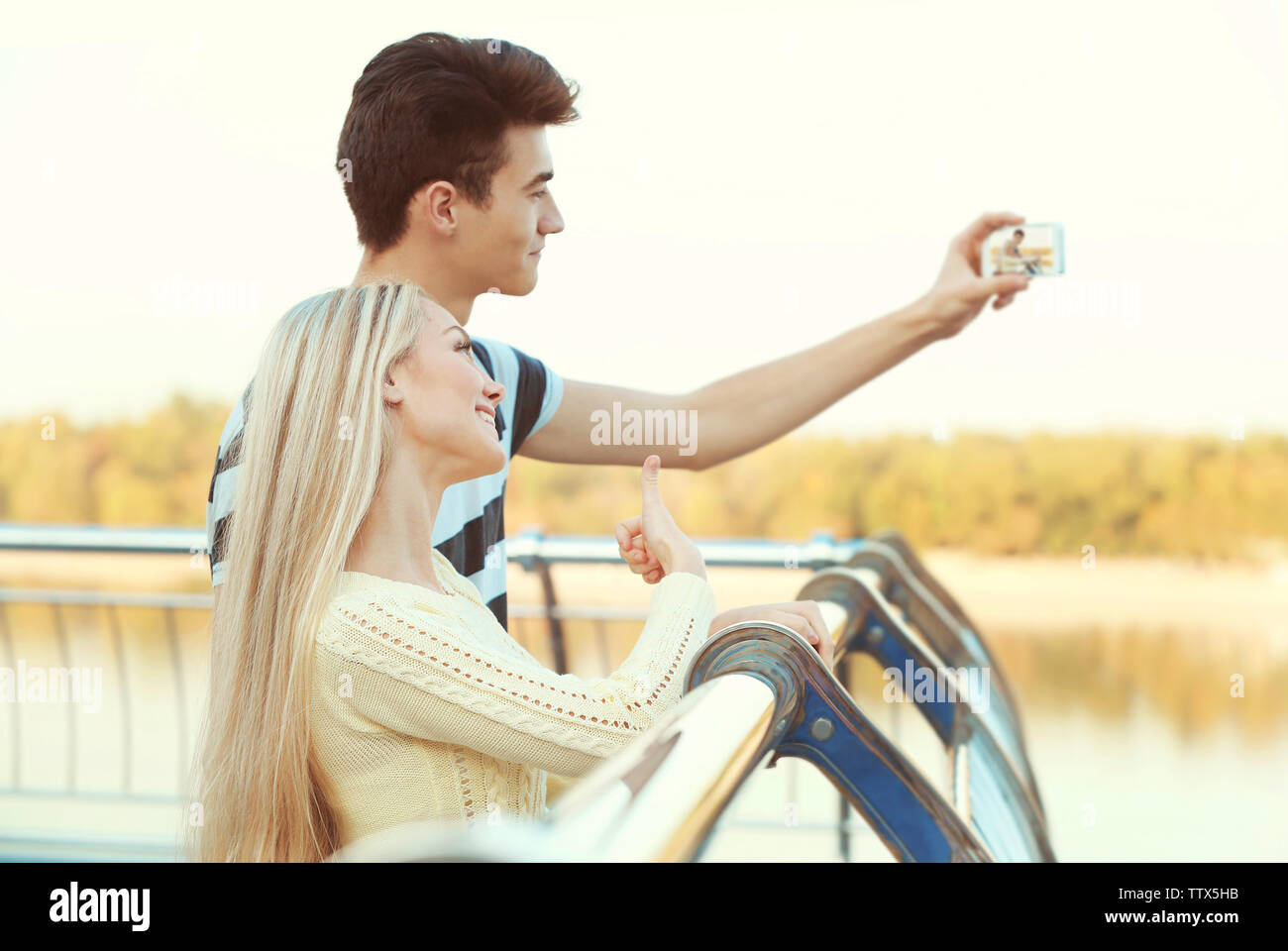 Beautiful young couple taking selfie outdoors Stock Photo