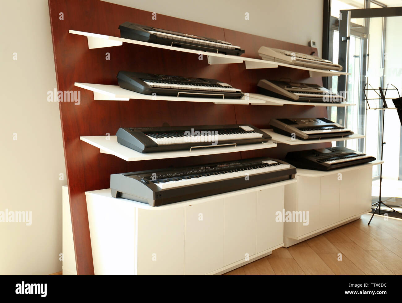 Synthesizers on shelves in music shop Stock Photo