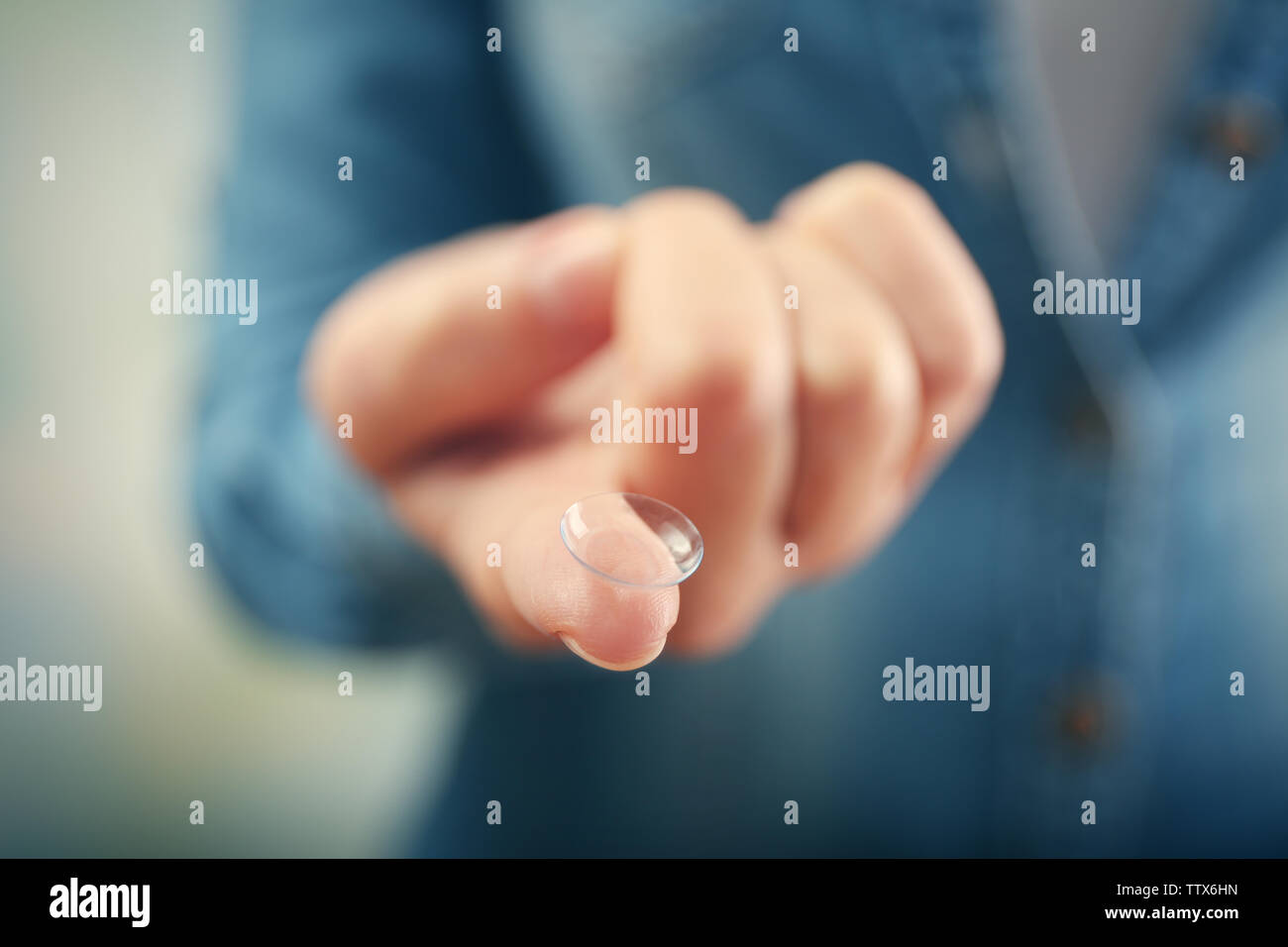 Contact lens on female finger, close up view. Medicine and vision concept Stock Photo