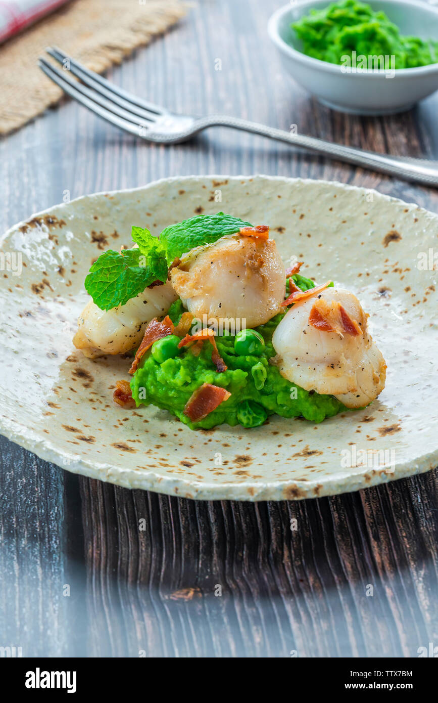 Scallops with minted peas and crispy pancetta closeup Stock Photo Alamy