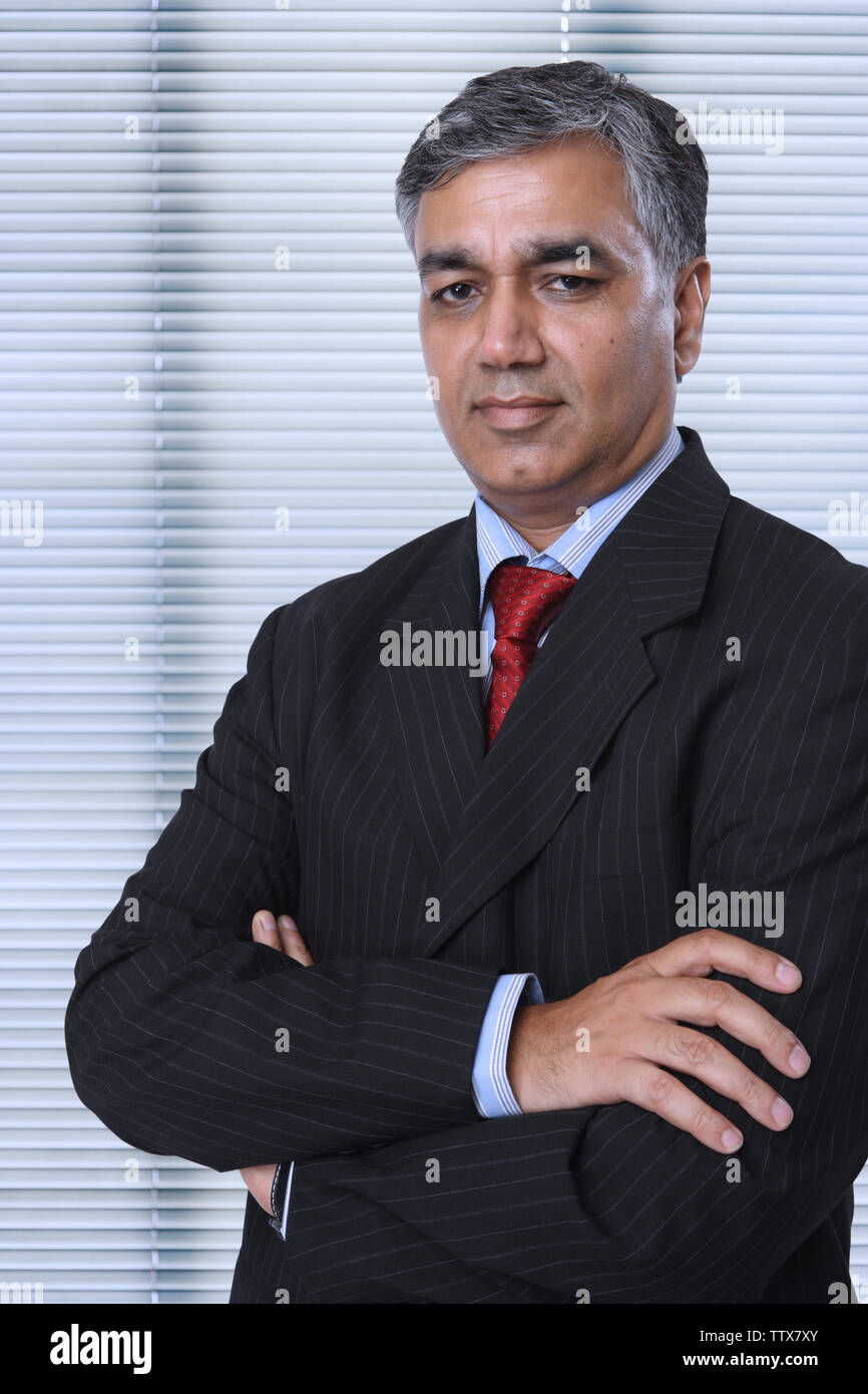 Portrait of a businessman with arms crossed Stock Photo - Alamy