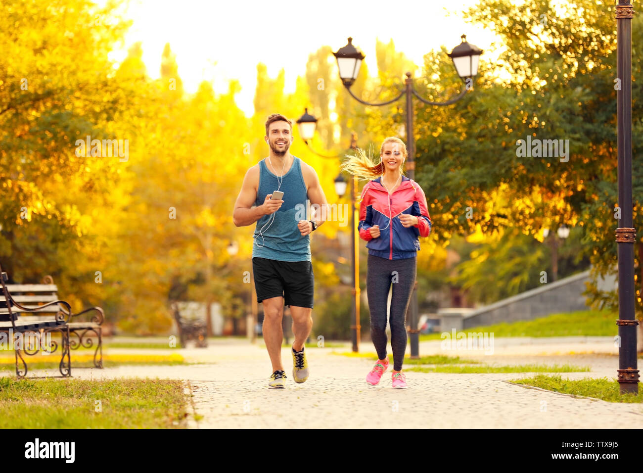 Running sportsmen in park hi-res stock photography and images - Alamy