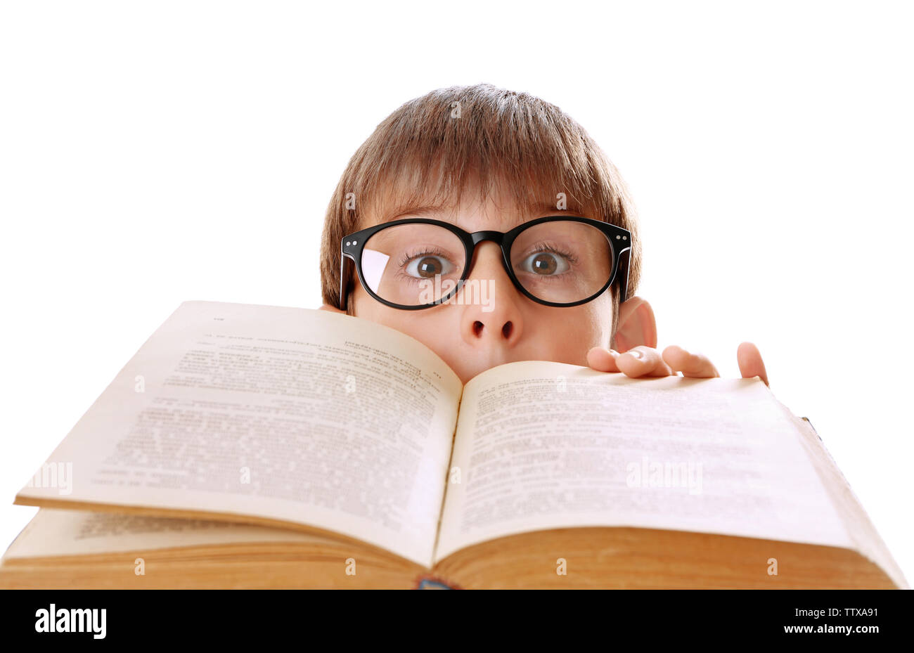 Cute schoolboy with book on white background Stock Photo - Alamy