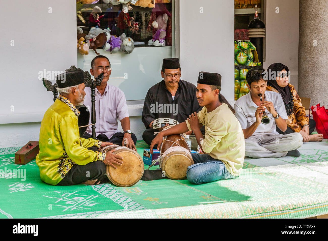 A band of Malayan musicians performing indigenous music and playing traditional instruments Stock Photo