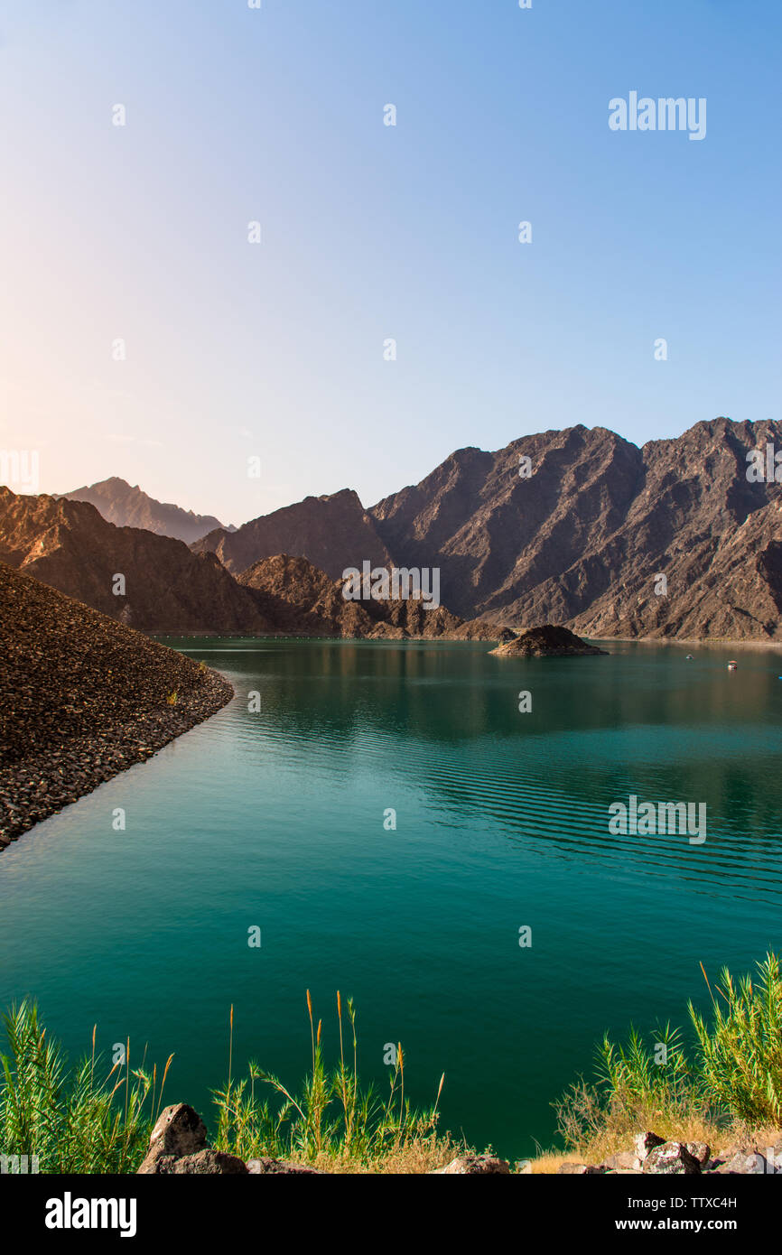 Breathtaking scenery of Hatta Dam best place to visit near Dubai beautiful sunrise view of Hatta lake famous place for kayaking boating and other acti Stock Photo