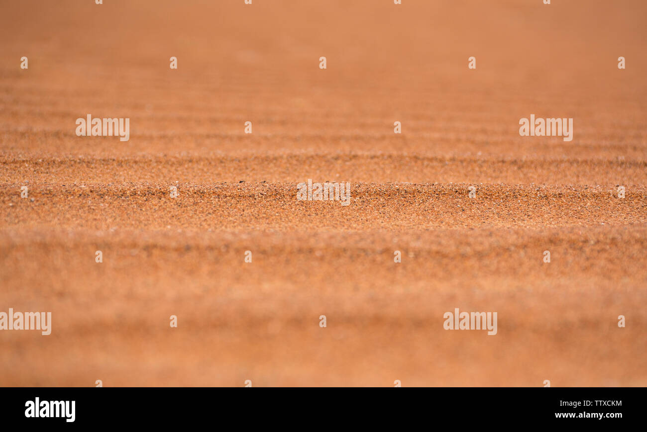 Closeup Shot of Desert Sand Dunes beautiful orange shade desert sand texture background Stock Photo