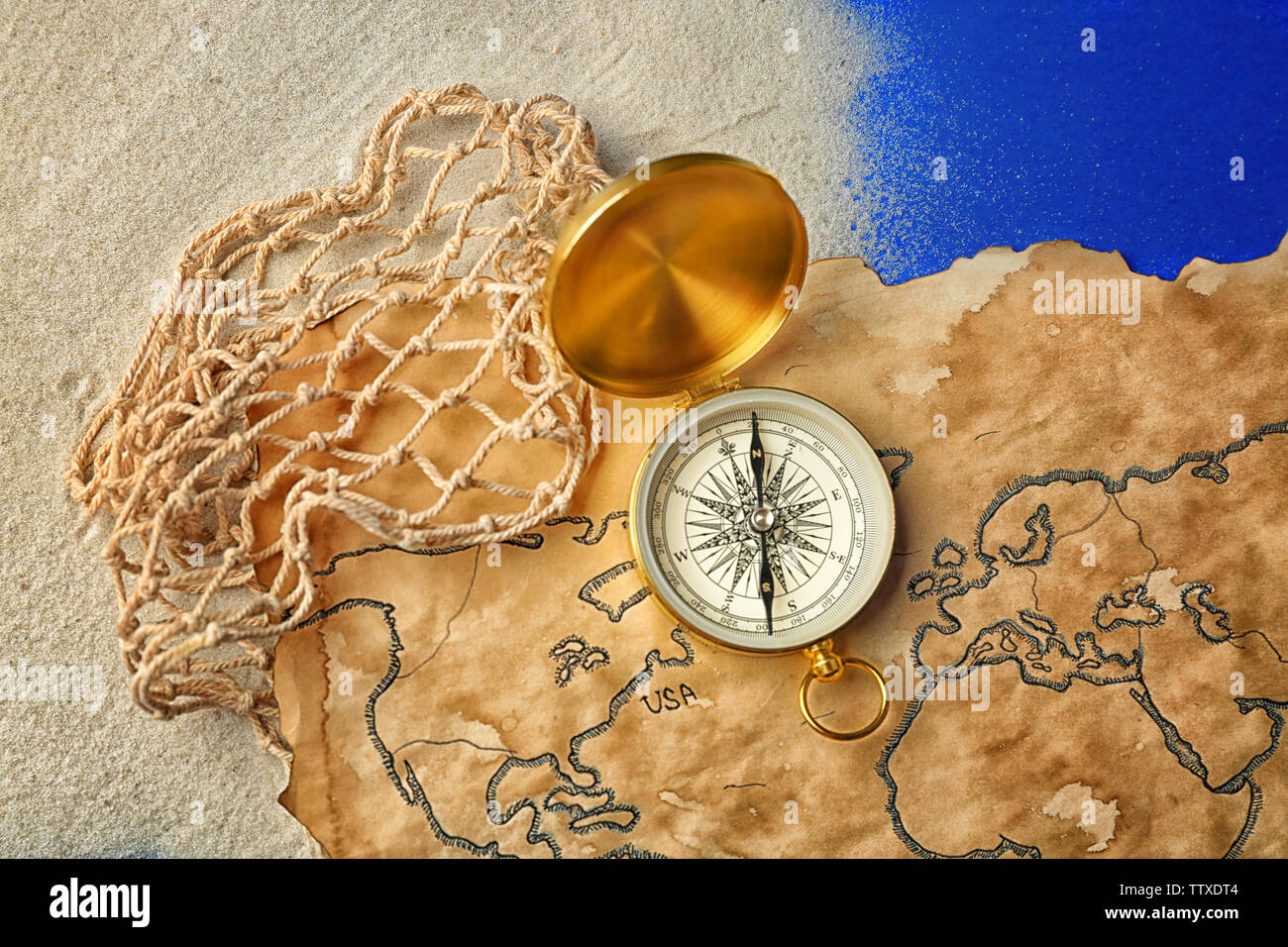 Compass Net Compass, net and old map on blue background. Columbus Day concept Stock ...