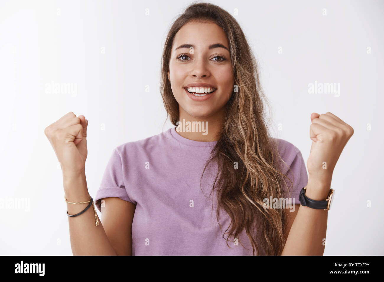 Waist-up happy celebrating relieved good-looking female receiving achievement successful accomplishment training, clenching fists victory win gesture Stock Photo
