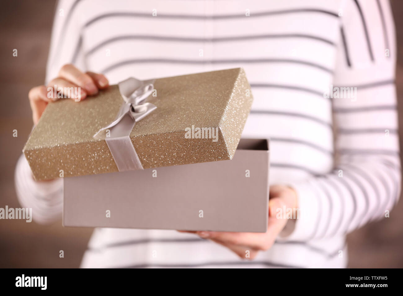 Woman holding Christmas gift, closeup Stock Photo - Alamy