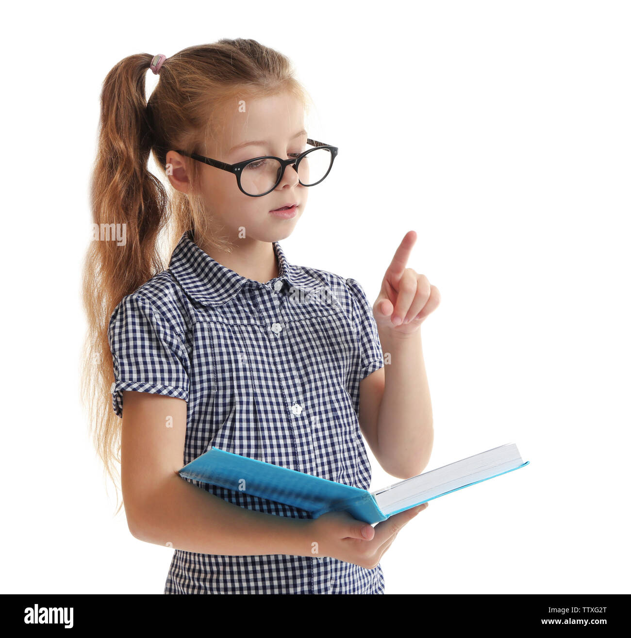 Cute little girl reading book on white background Stock Photo - Alamy