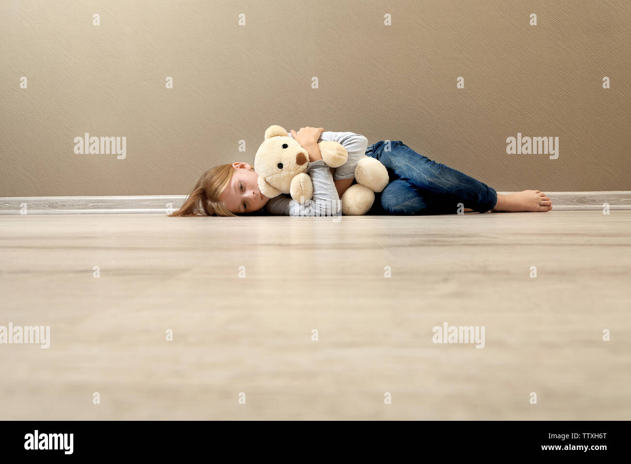 Depressed girl lying on floor hi-res stock photography and images - Alamy