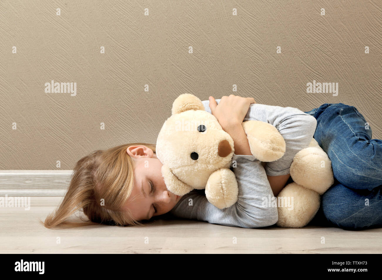 Depressed girl lying on floor hi-res stock photography and images - Alamy