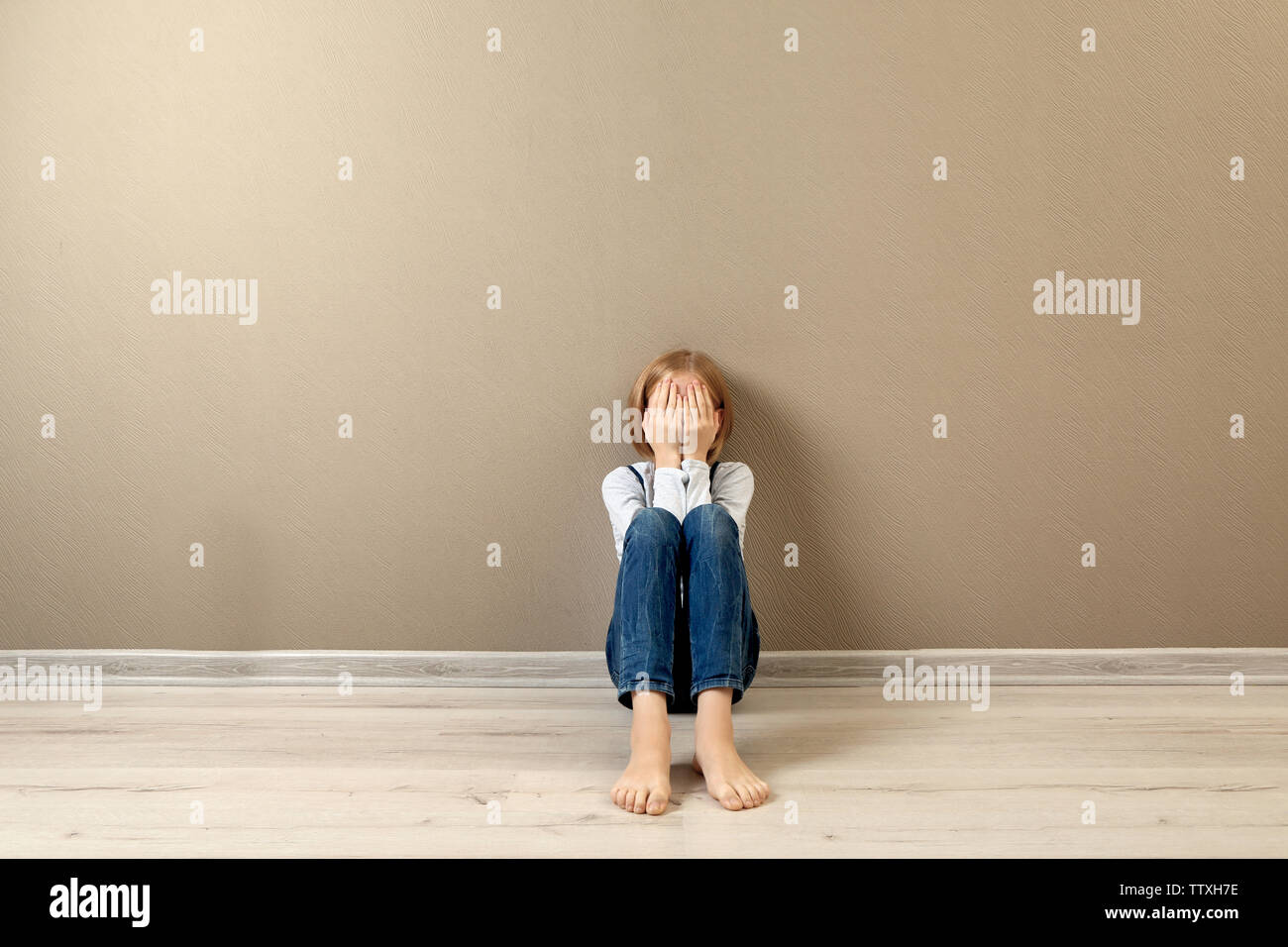 Upset girl sitting on the floor at home Stock Photo - Alamy