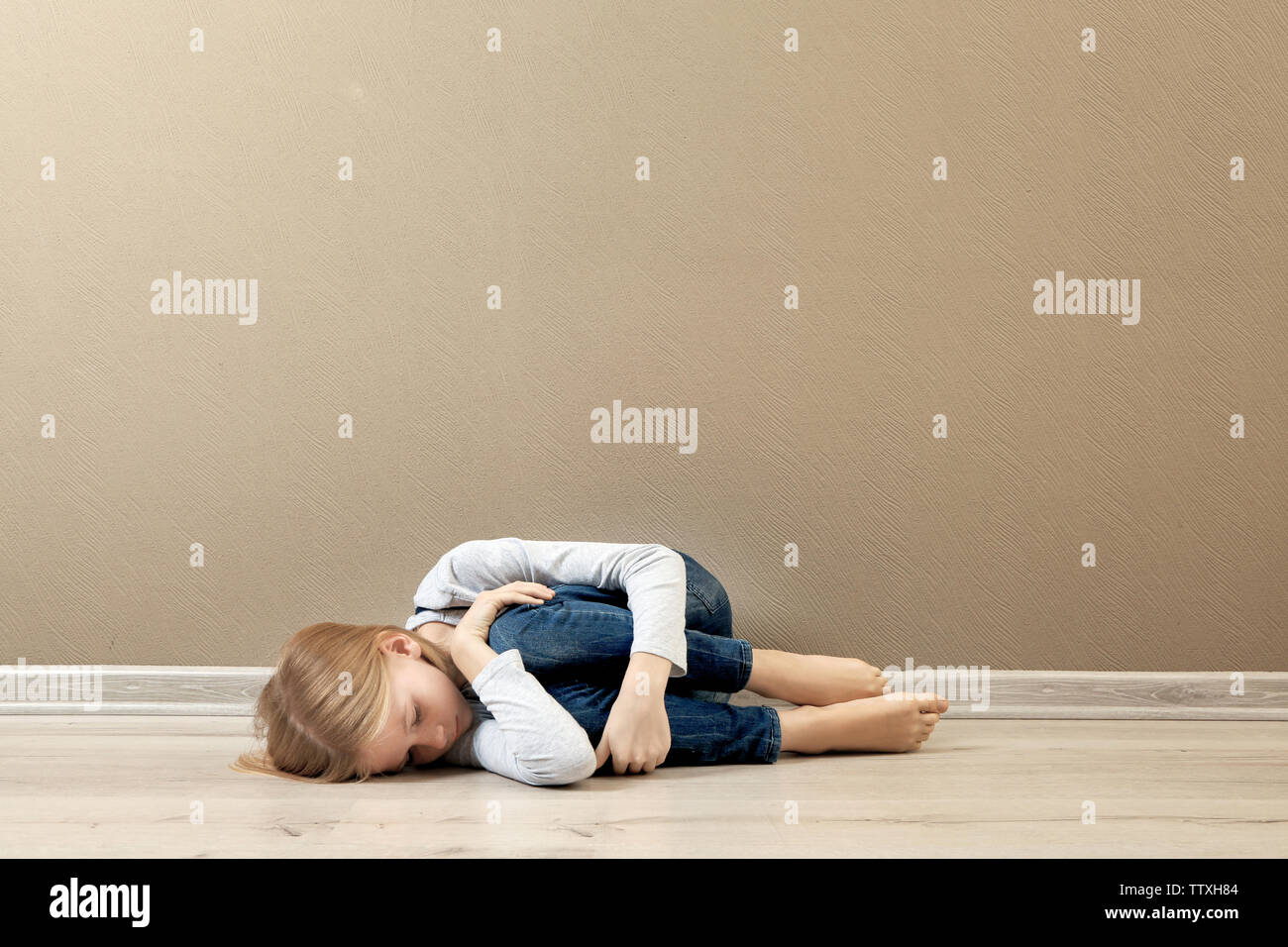 Depressed girl lying on floor hi-res stock photography and images - Alamy