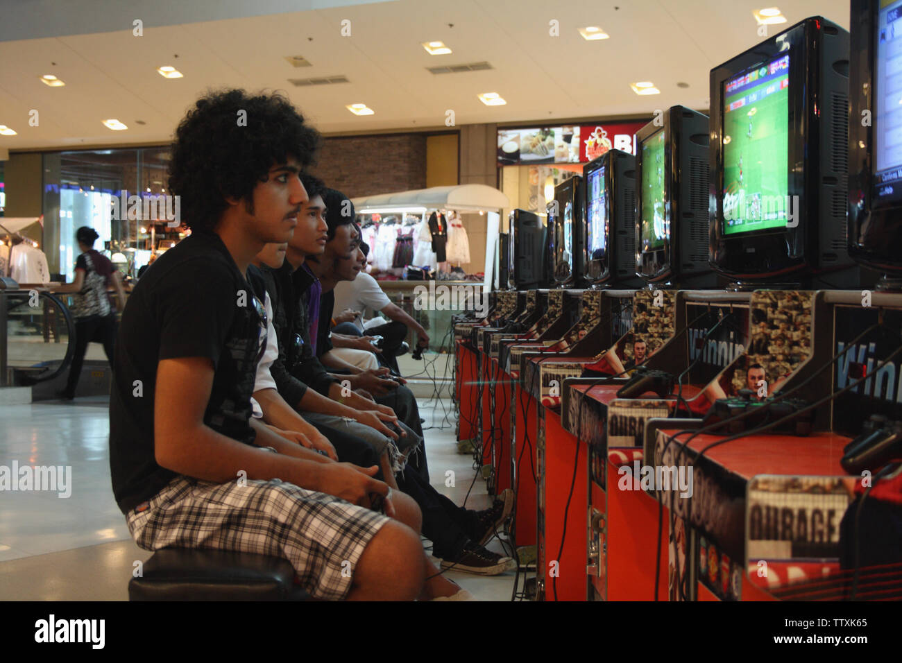 People playing arcade game, Phuket, Thailand Stock Photo