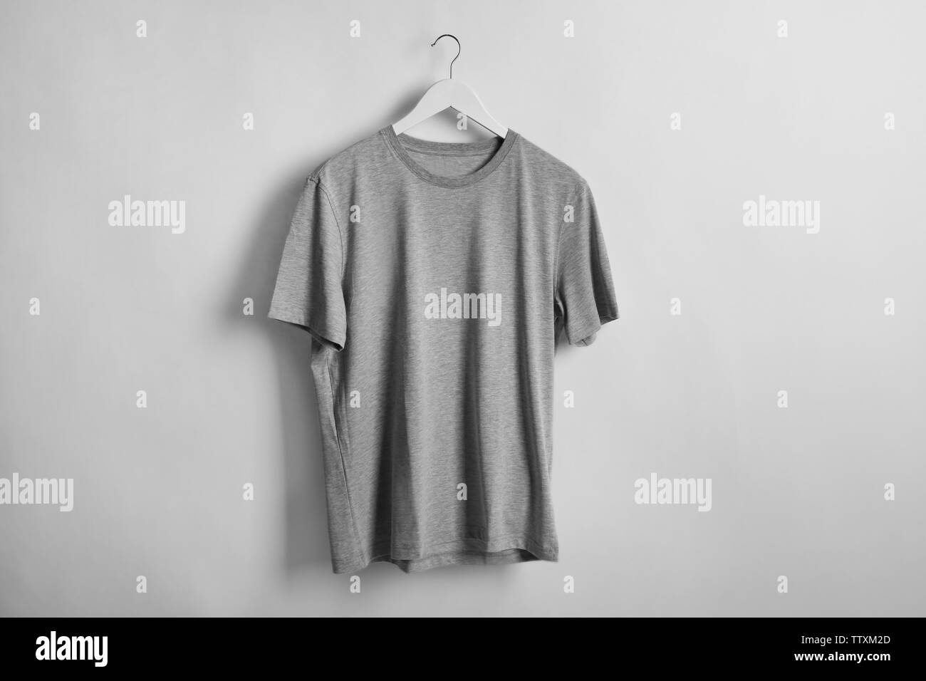 Blank grey t-shirt on light background Stock Photo - Alamy