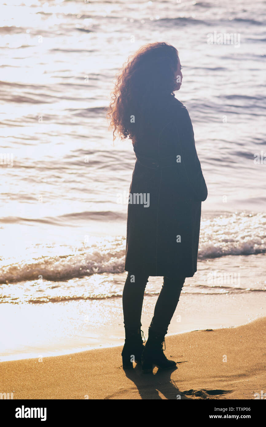 Young woman Standingon the beach Stock Photo - Alamy