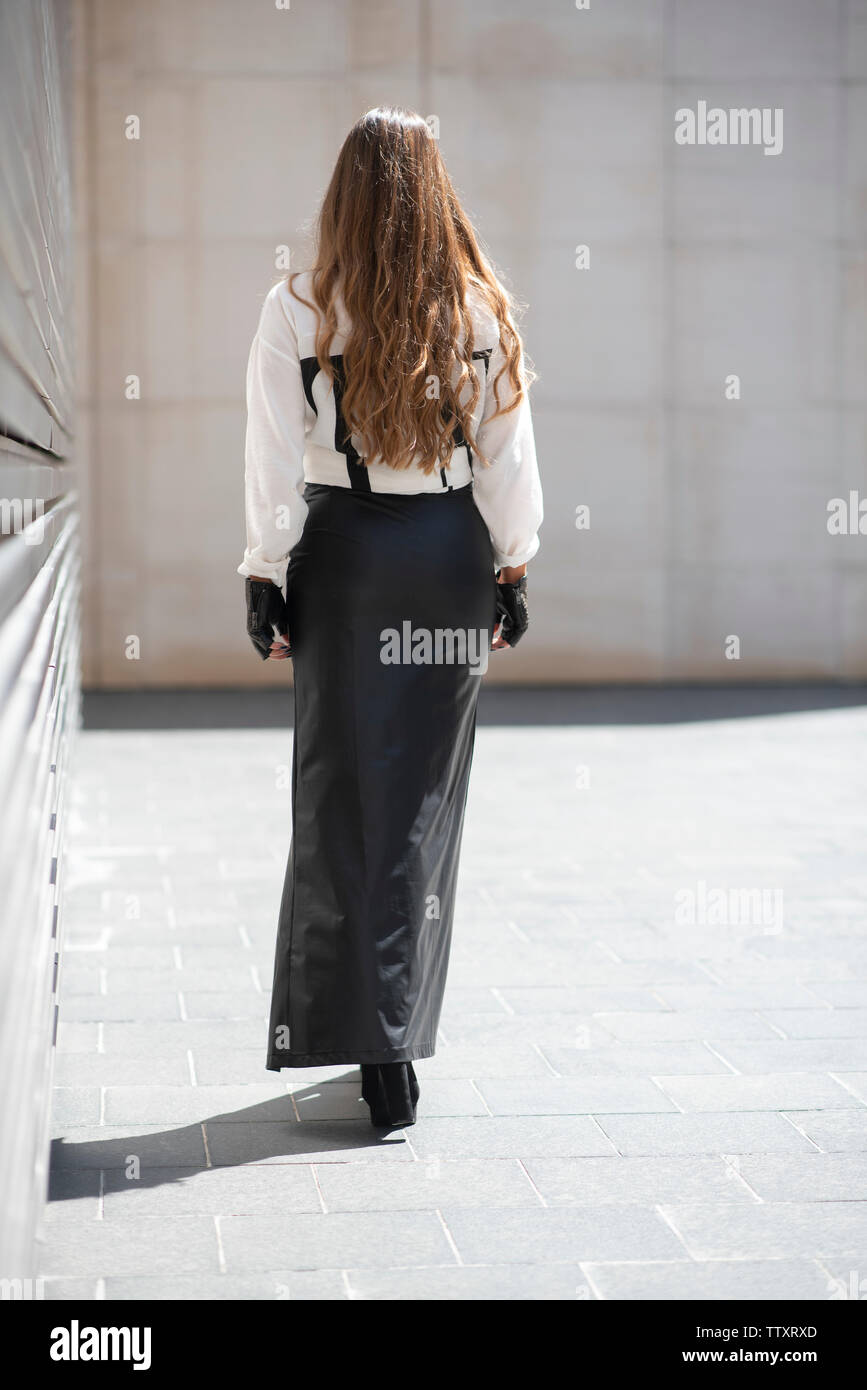 Woman long skirt walking away hi-res stock photography and images - Alamy
