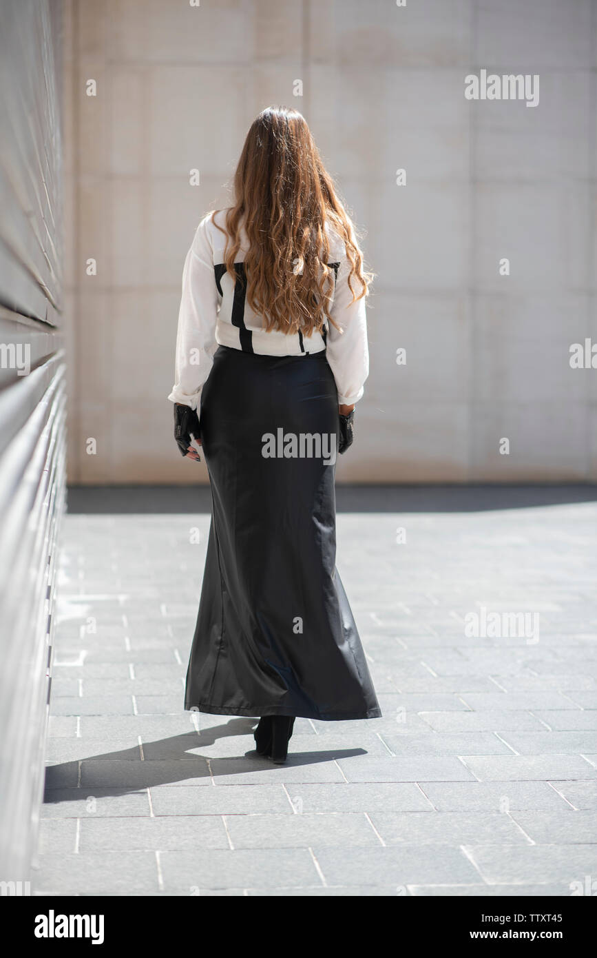 Woman long skirt walking away hi-res stock photography and images - Alamy
