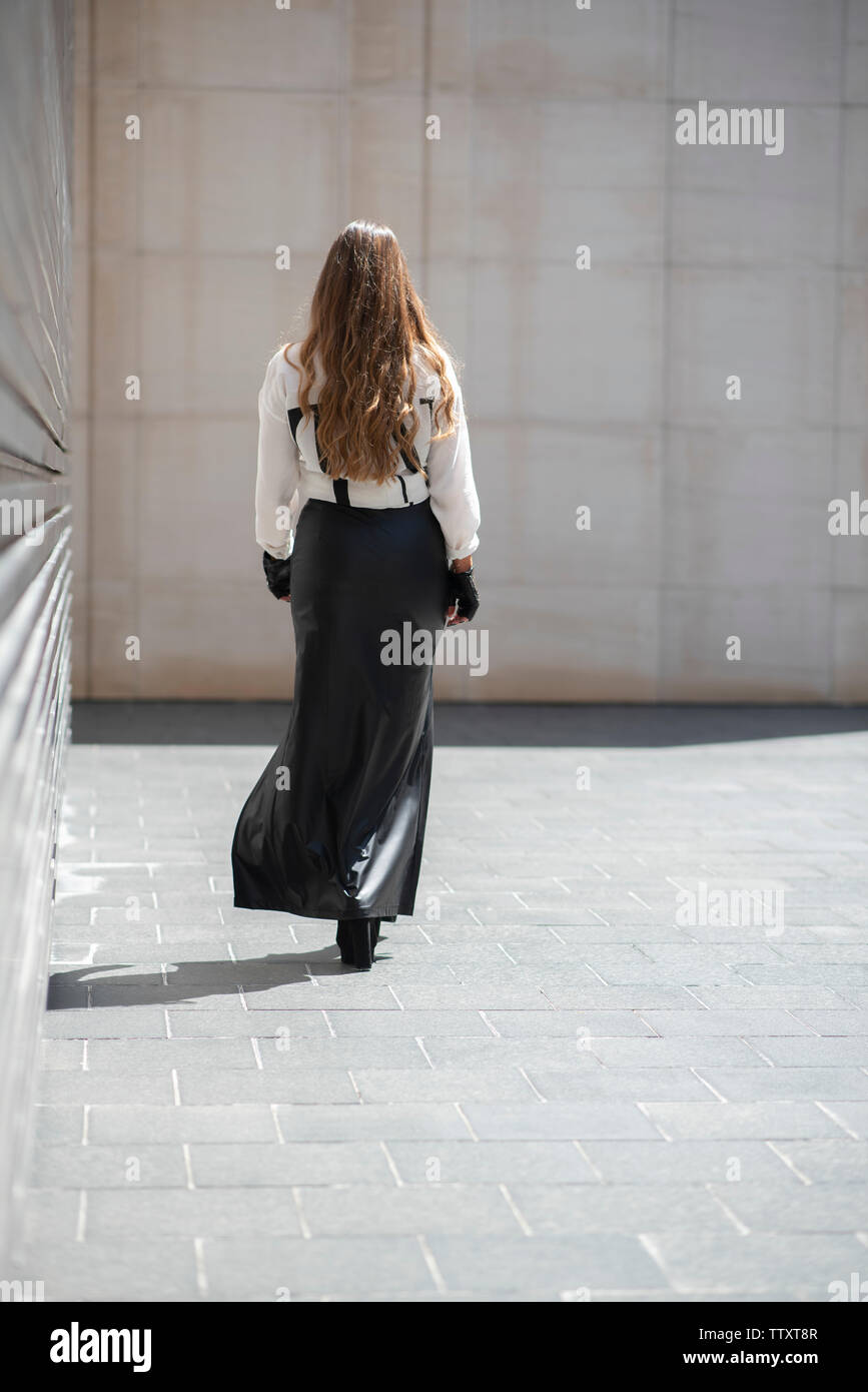Woman long skirt walking away hi-res stock photography and images - Alamy