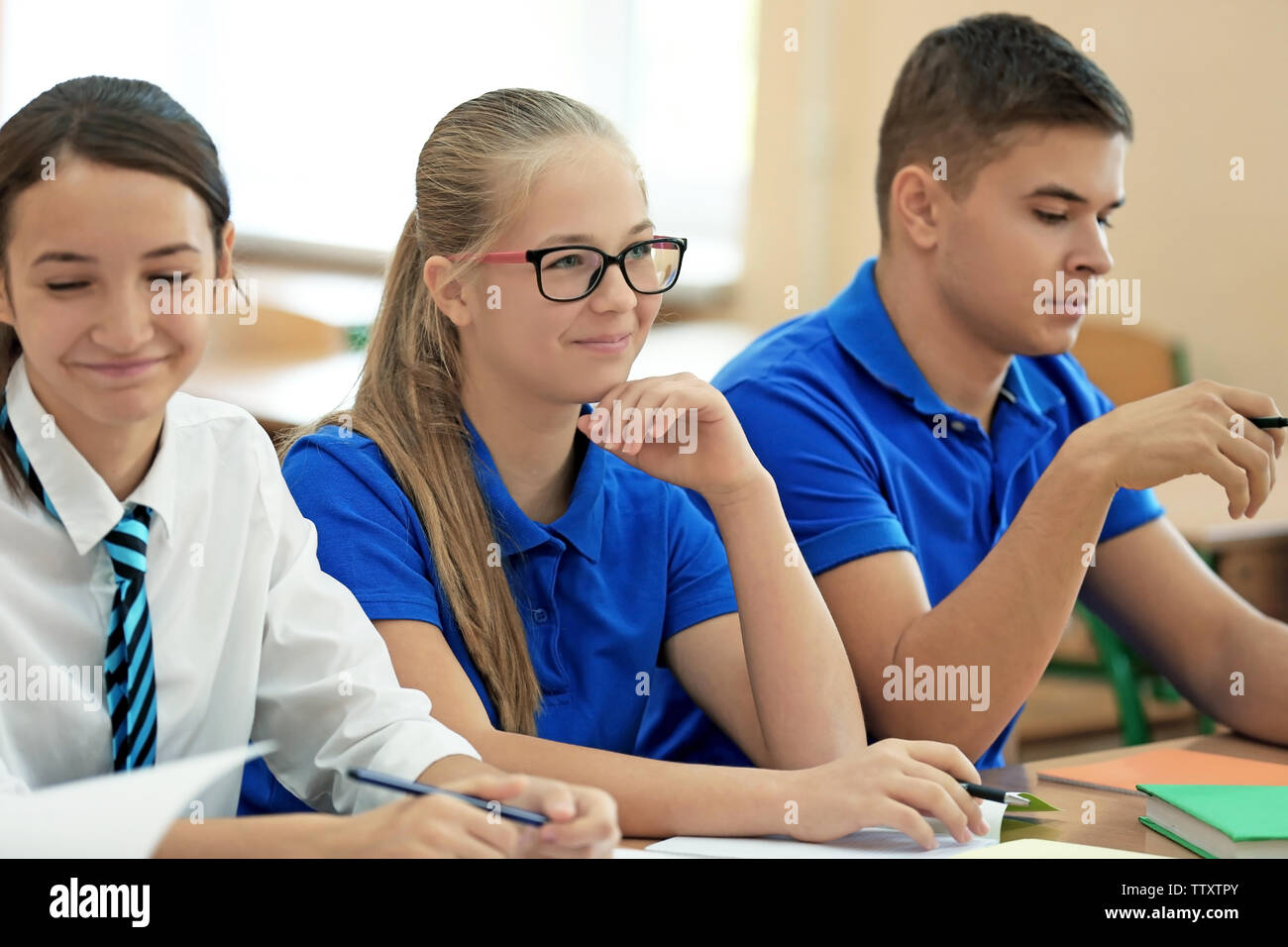 Classmate friends in classroom Stock Photo - Alamy